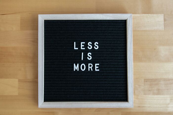 Black felt letter board with white letters spelling less is more, illustrating commonly misheard phrases in everyday English learning. Black felt letter board with white letters spelling less is more, illustrating commonly misheard phrases in everyday English learning.