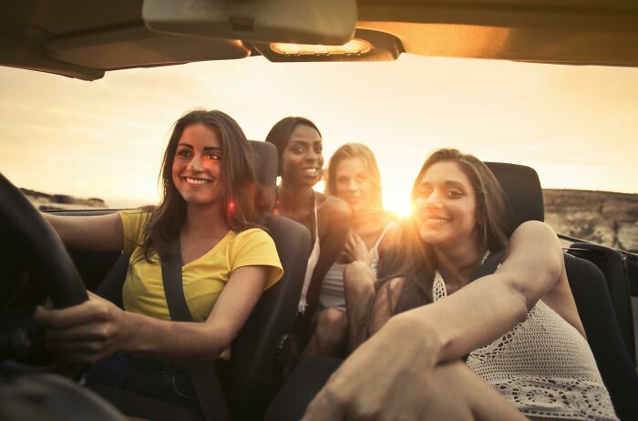 Group of young women enjoying a sunset car ride capturing relatable middle class lifestyle moments shared by netizens