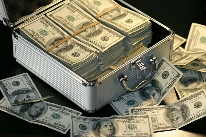 Briefcase filled with stacks of hundred-dollar bills representing wealth and success tied to Forbes list 2025 aspirations. Briefcase filled with stacks of hundred-dollar bills representing wealth and success tied to Forbes list 2025 aspirations.