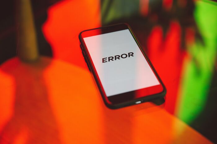 Smartphone displaying error message on screen, symbolizing subtle signs of incredibly low self-esteem online discussion.