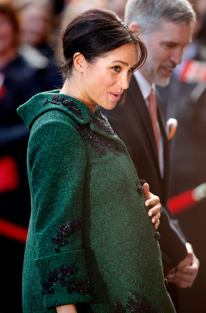 Meghan Markle wearing a green coat, holding her baby bump, amid renewed twerking pregnancy video conspiracy theory. Meghan Markle wearing a green coat, holding her baby bump, amid renewed twerking pregnancy video conspiracy theory.