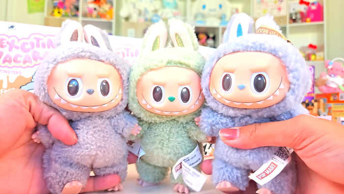 Three small plush toys with bunny ears held by hands, illustrating rich kid meltdowns at private schools.