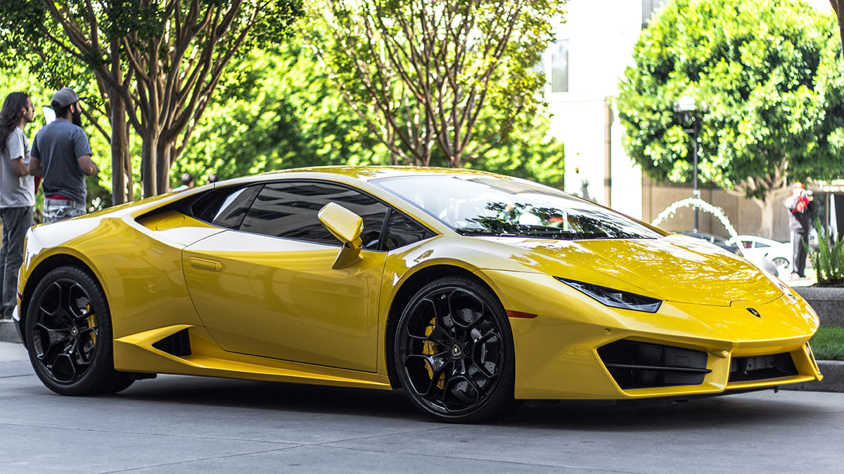 Yellow luxury sports car parked on a city street, symbolizing rich kid meltdowns at private schools.