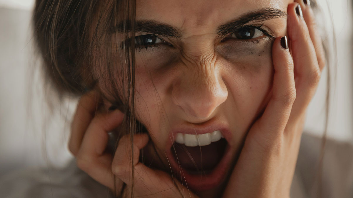 Close-up of a distressed woman showing fear and anxiety, illustrating psychologistsu2019 experiences with patients who genuinely scared them.