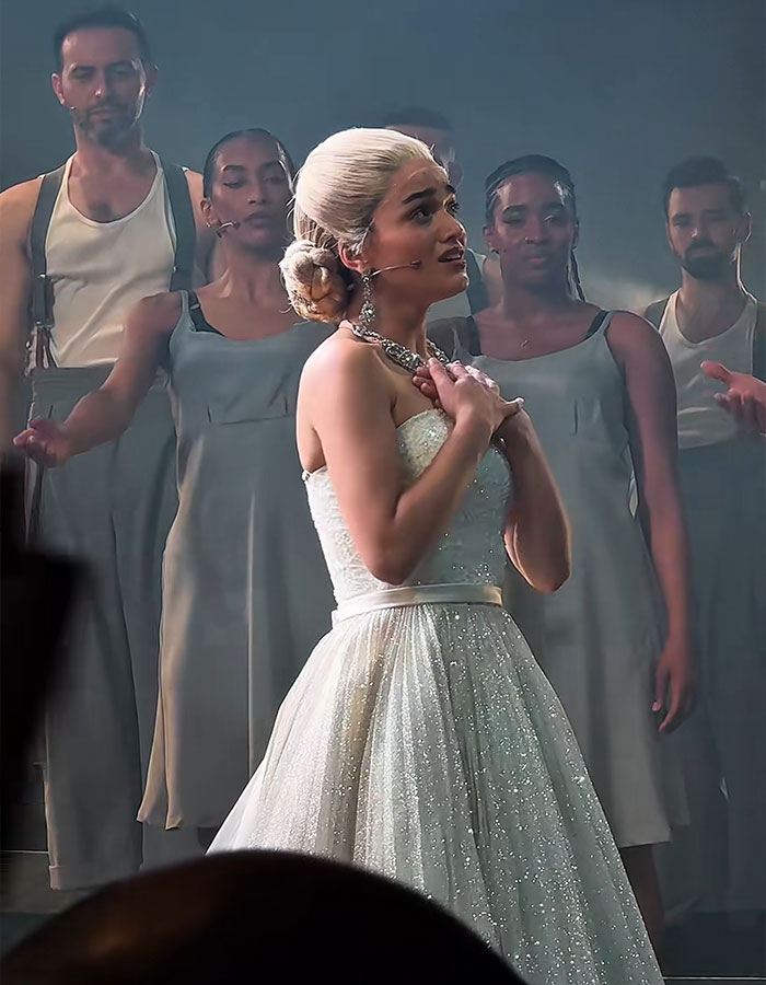 Rachel Zegler performing on stage with backup dancers, sparking outrage among fans during a live show event. Rachel Zegler performing on stage with backup dancers, sparking outrage among fans during a live show event.