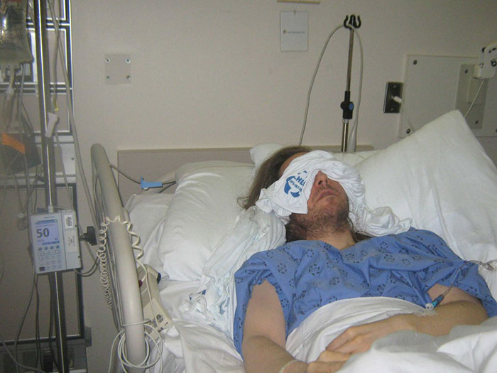 Man trapped in hospital bed for years, exposed mistreatment by staff, lying with cloth over eyes in medical gown. Man trapped in hospital bed for years, exposed mistreatment by staff, lying with cloth over eyes in medical gown.