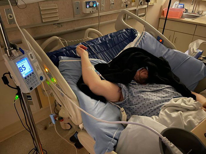 Man in hospital bed with medical equipment, highlighting man trapped in hospital and exposing staff misconduct. Man in hospital bed with medical equipment, highlighting man trapped in hospital and exposing staff misconduct.