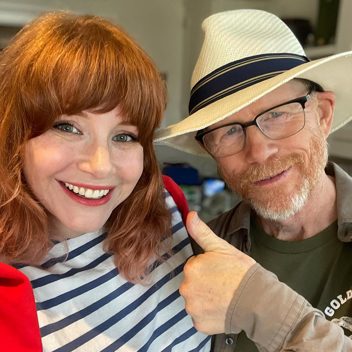 Bryce Dallas Howard and Ron Howard smiling together, highlighting nepotism and her challenging childhood experiences. Bryce Dallas Howard and Ron Howard smiling together, highlighting nepotism and her challenging childhood experiences.