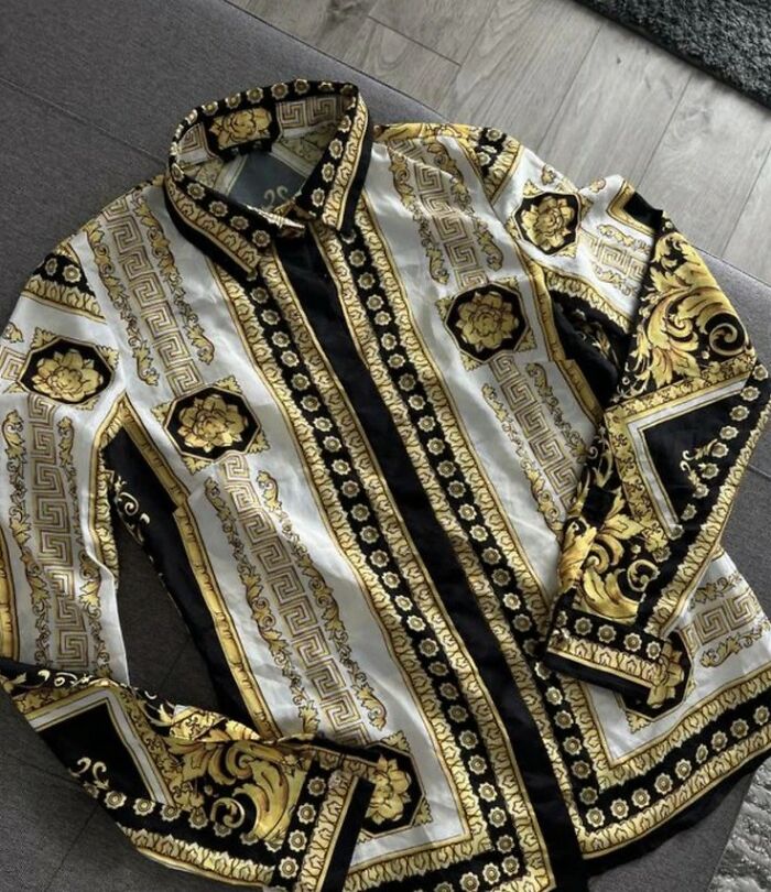 Patterned shirt with intricate gold and black designs laid out to highlight a priceless reward after spending just a dollar