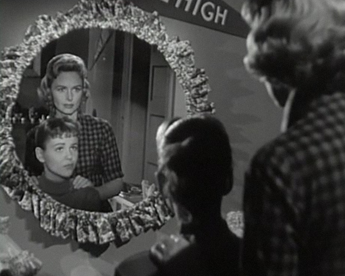Black and white image of iconic sitcom legend and young boy reflected in mirror during a rare public outing. Black and white image of iconic sitcom legend and young boy reflected in mirror during a rare public outing.