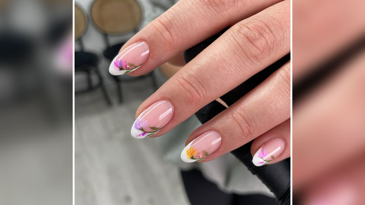 Short French tip nails with delicate floral design on a natural pink base, showcasing stylish nail art for 2025 trends.