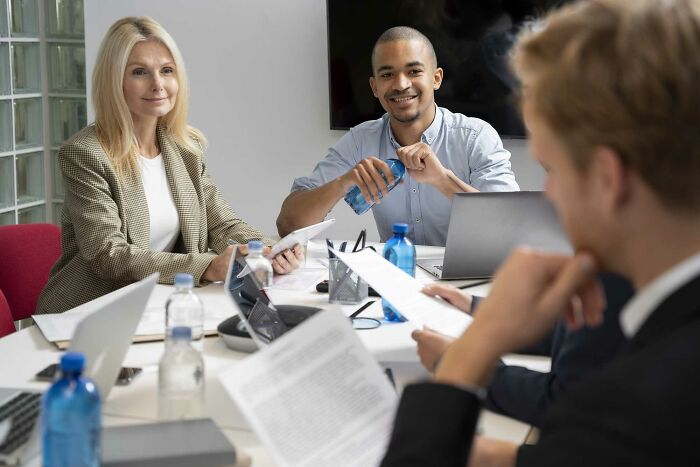 Group of diverse colleagues in a meeting, demonstrating challenges of being shy in a professional environment.