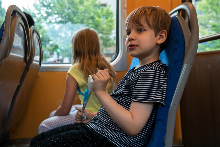 Two shy children sitting quietly on a bus, illustrating moments when being shy made social situations worse.