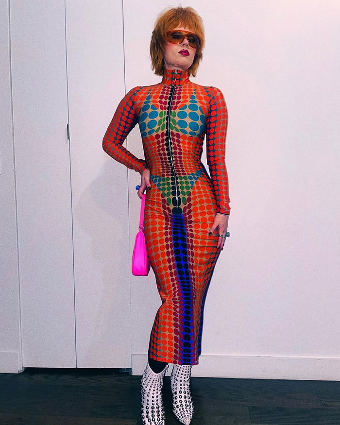 Person in a colorful patterned dress and sunglasses, showcasing child star's unrecognizable transformation and bold style. Person in a colorful patterned dress and sunglasses, showcasing child star's unrecognizable transformation and bold style.