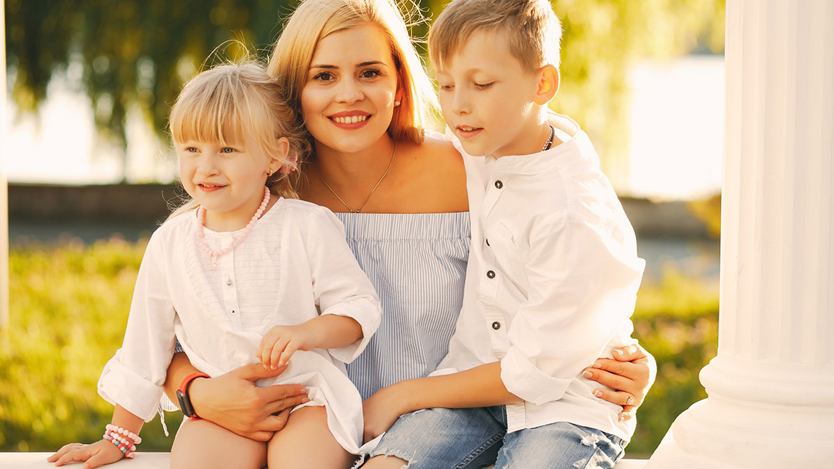 Young woman with two kids outdoors showing mom expects endless babysitting from sister in a family setting