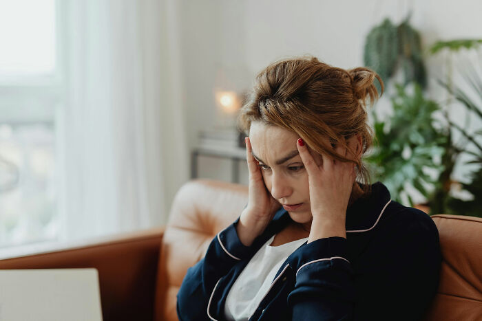 Wife who raised stepdaughters looking stressed and worried, avoiding conflict with husband’s volatile ex-wife at home. Wife who raised stepdaughters looking stressed and worried, avoiding conflict with husband’s volatile ex-wife at home.