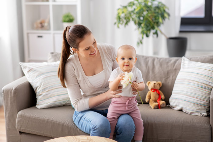 Woman babysitting a baby on a couch, illustrating child-free lady warning sis against too much babysitting. Woman babysitting a baby on a couch, illustrating child-free lady warning sis against too much babysitting.