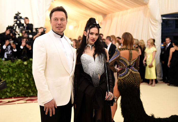 Elon Musk and Grimes posing together at a formal event, related to Tau Techno Mechanicus and the Musk family saga. Elon Musk and Grimes posing together at a formal event, related to Tau Techno Mechanicus and the Musk family saga.