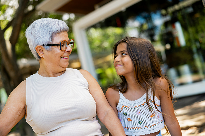 Teen girl looking uncertain while spending time with an older woman outside, reflecting struggle babysit step siblings.