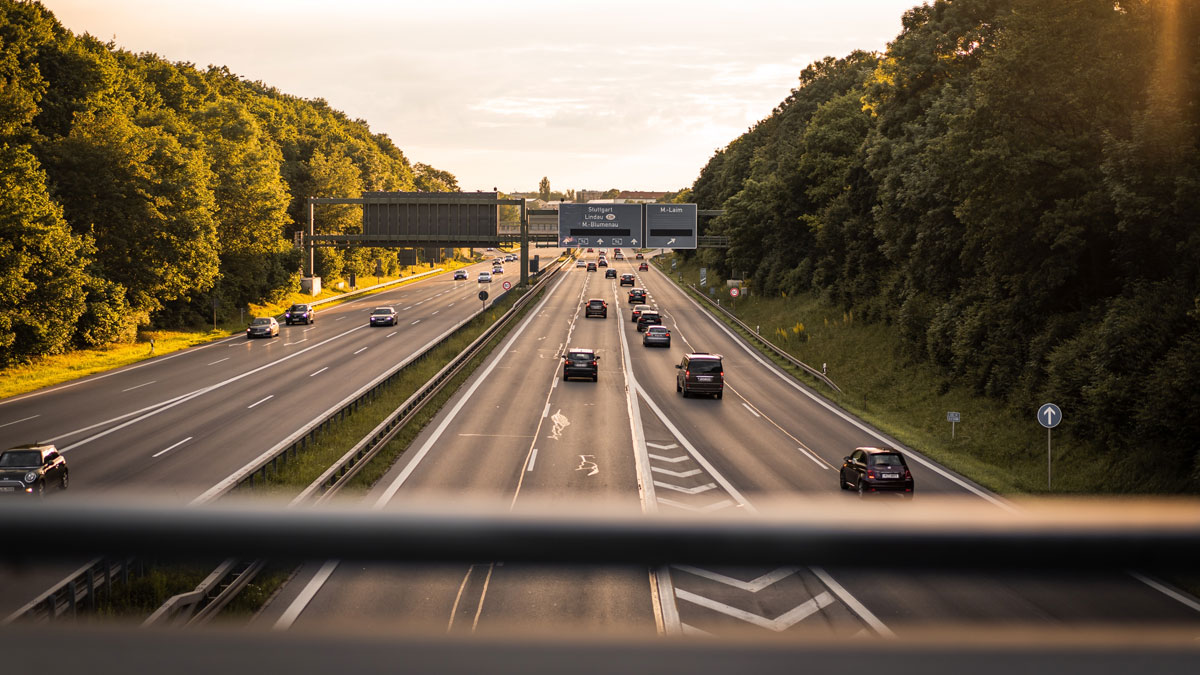Highway scene with cars driving at sunset surrounded by trees, illustrating everyday facts not everyone knows.