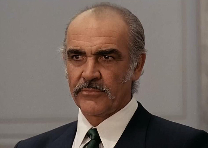 Sean Connery in a formal suit with mustache and greying hair, representing iconic James Bond actor at same age debate. Sean Connery in a formal suit with mustache and greying hair, representing iconic James Bond actor at same age debate.