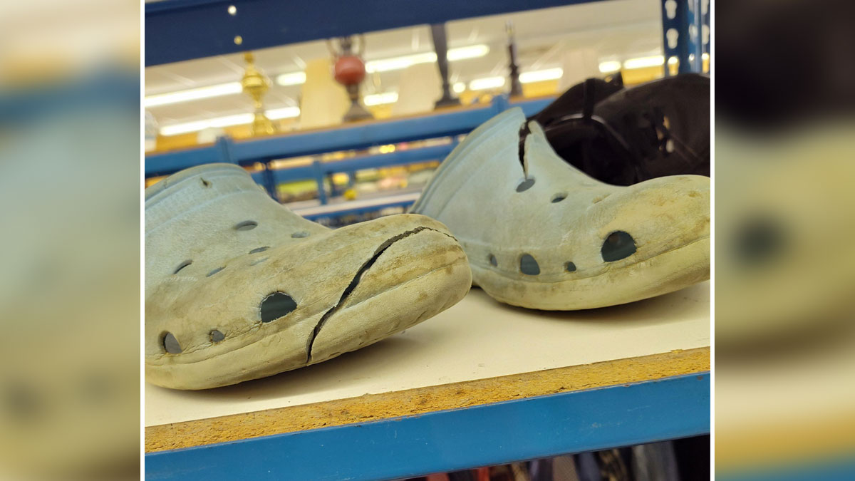 Worn-out c*****d shoes on a shelf at a thrift store, showing a ridiculous find from thrift store shopping.