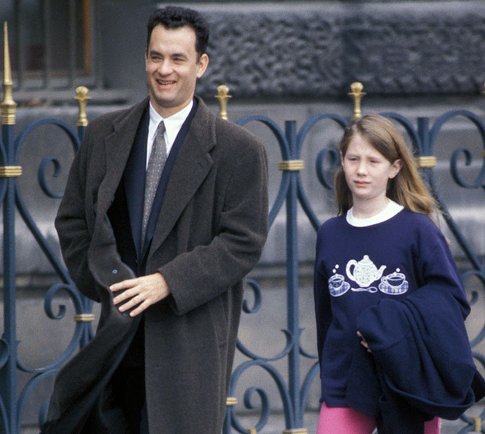 Tom Hanks walking outdoors with daughter, reflecting on childhood confusion, violence, and deprivation revelations. Tom Hanks walking outdoors with daughter, reflecting on childhood confusion, violence, and deprivation revelations.