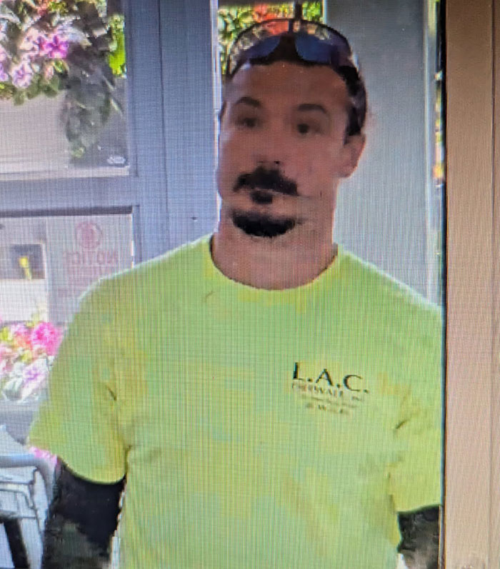 Man in a yellow shirt standing indoors near a window, related to blood evidence found where fugitive dad harmed his daughters. Man in a yellow shirt standing indoors near a window, related to blood evidence found where fugitive dad harmed his daughters.