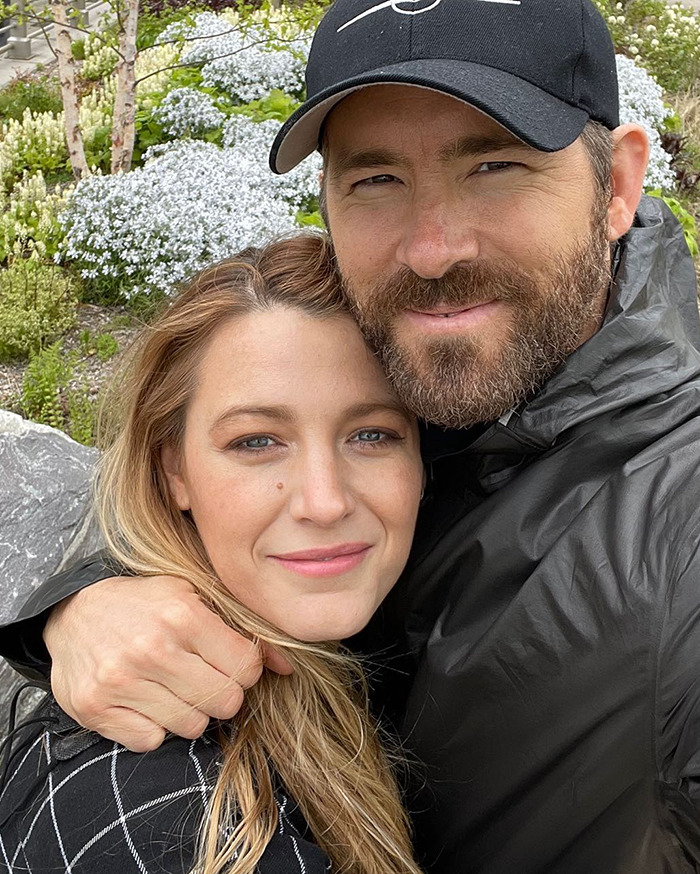 Blake Lively and Justin Baldoni posing closely outdoors with flowers in the background related to lawsuit news. Blake Lively and Justin Baldoni posing closely outdoors with flowers in the background related to lawsuit news.