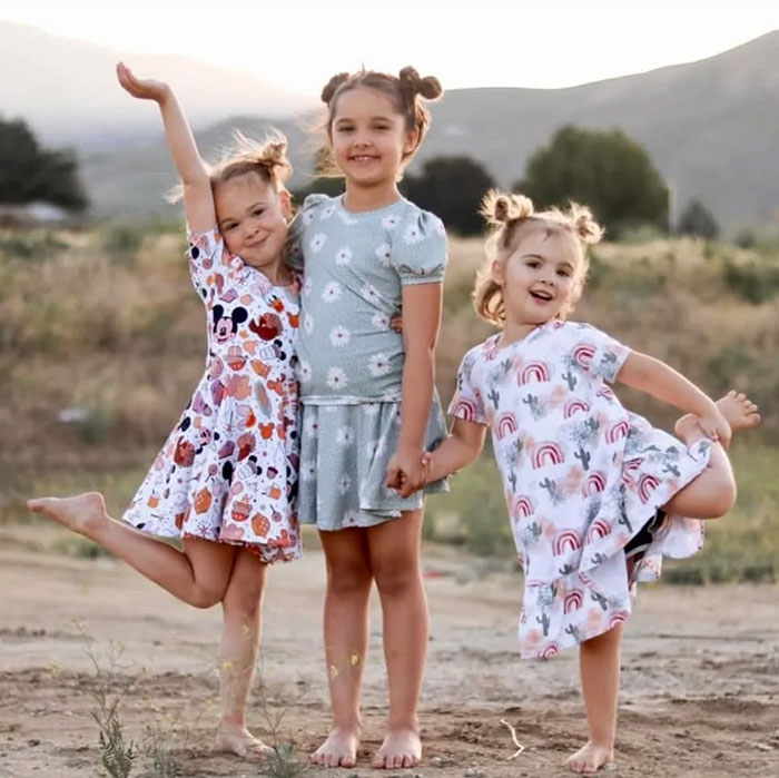 Three young girls holding hands and posing outdoors, related to blood evidence found near fugitive dad's case. Three young girls holding hands and posing outdoors, related to blood evidence found near fugitive dad's case.