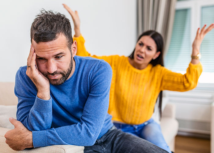 Frustrated woman arguing with husband who looks upset, illustrating a conversation about being a tradwife at home. Frustrated woman arguing with husband who looks upset, illustrating a conversation about being a tradwife at home.