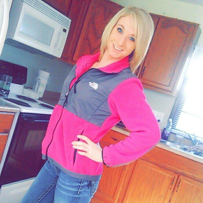 Young caring mother posing in kitchen wearing pink jacket, known for portion of jaw missing before naming alleged attacker. Young caring mother posing in kitchen wearing pink jacket, known for portion of jaw missing before naming alleged attacker.