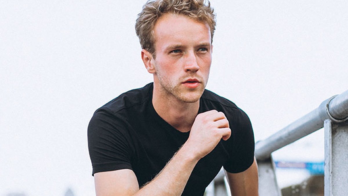 Young man in black shirt looking thoughtful outdoors, related to unhinged things men have said about looks in public.