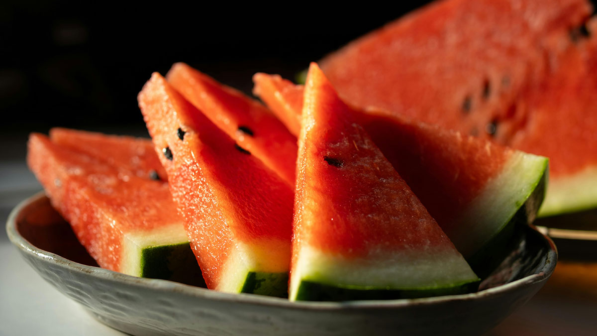 Close-up of fresh watermelon slices on a plate, highlighting a buffet workers wildest encounters with food.