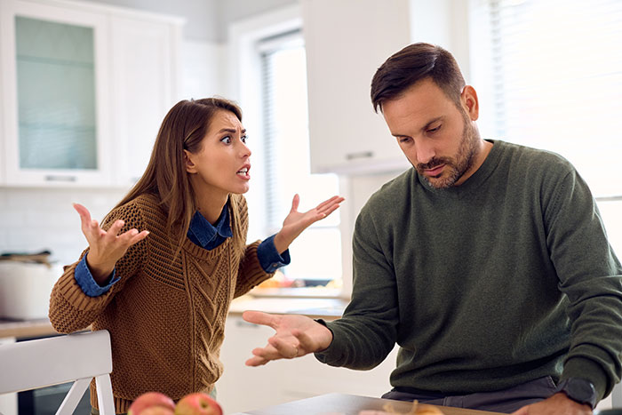 Woman upset and arguing with partner in kitchen, highlighting issues of cheating and co-parenting children with others. Woman upset and arguing with partner in kitchen, highlighting issues of cheating and co-parenting children with others.