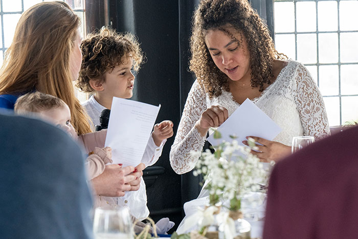 Bride in a white lace dress interacting with guests at a wedding, reflecting on neutrals and color choices. Bride in a white lace dress interacting with guests at a wedding, reflecting on neutrals and color choices.