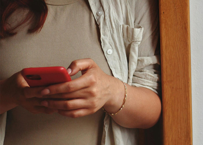 Woman rethinks her relationship holding a phone, showing concern after a red-flag argument with her boyfriend. Woman rethinks her relationship holding a phone, showing concern after a red-flag argument with her boyfriend.