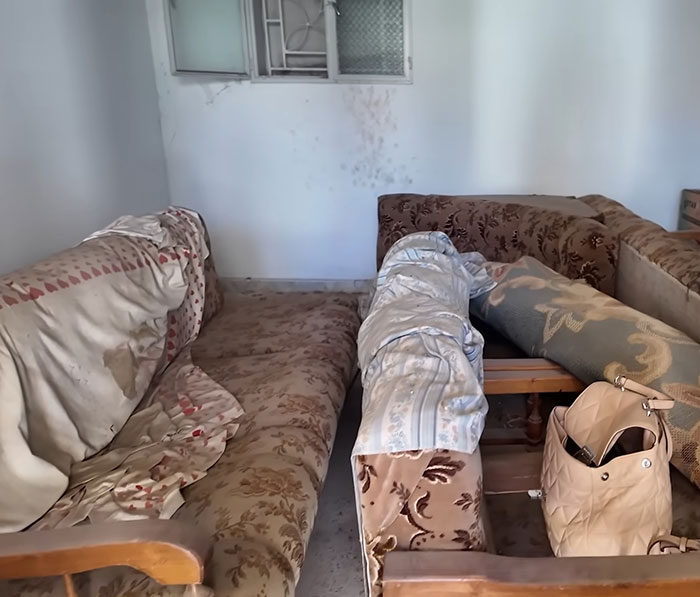Old family home interior with worn couches and a bag, symbolizing a woman’s visit 46 years after dad left. Old family home interior with worn couches and a bag, symbolizing a woman’s visit 46 years after dad left.