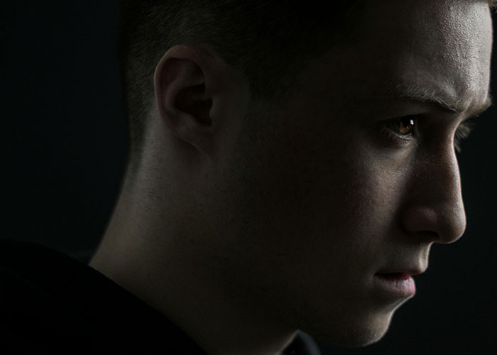 Close-up of a young man with a serious expression, illustrating red-flag argument fears in a troubled relationship. Close-up of a young man with a serious expression, illustrating red-flag argument fears in a troubled relationship.