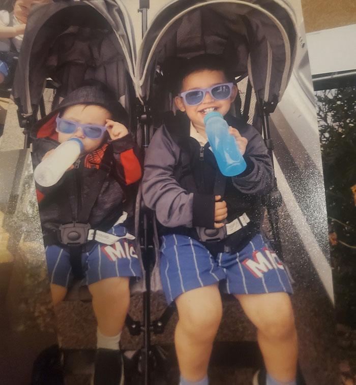 Two young boys wearing sunglasses, sitting in a double stroller drinking from bottles, main SEO keywords car baby lost life.