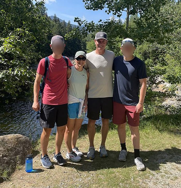 Four people posing outdoors near a river during a hike, relating to Coldplay HR exec mortgage news. Four people posing outdoors near a river during a hike, relating to Coldplay HR exec mortgage news.