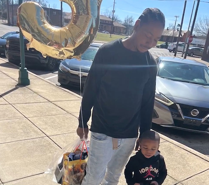 Man holding a gold balloon with a young boy, related to 3-year-old boy in temporary foster care news. Man holding a gold balloon with a young boy, related to 3-year-old boy in temporary foster care news.