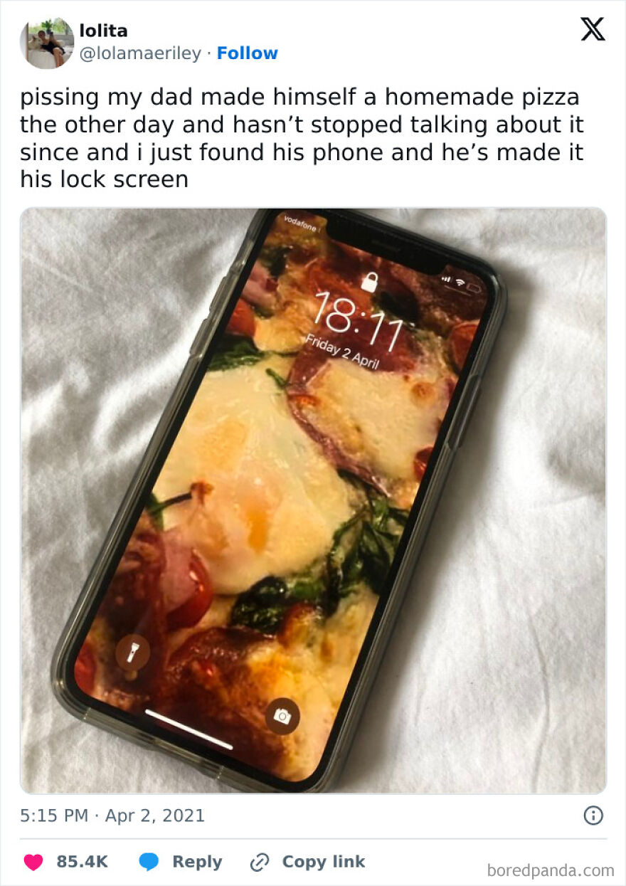 Smartphone lock screen showing homemade pizza photo, capturing a funny moment for daily British humor memes.