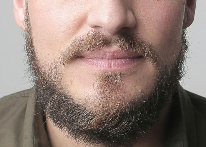 Close-up of a man’s face with a thick beard, illustrating bizarre family habits people thought were normal.