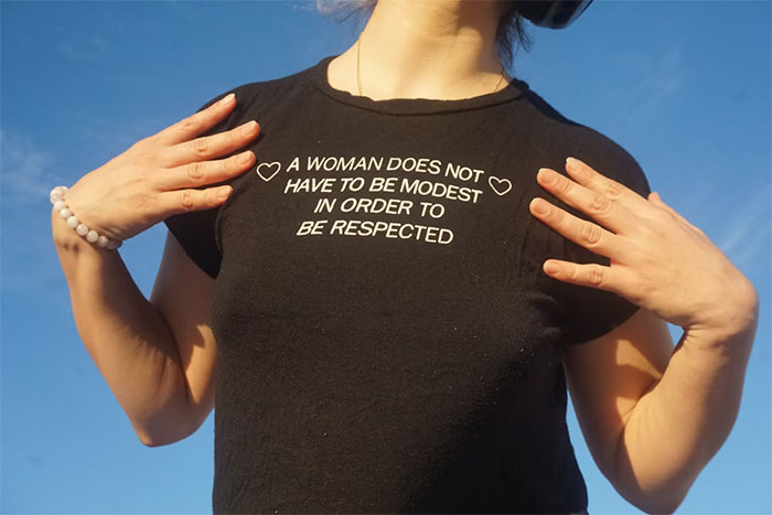 Woman wearing black shirt with message about respect, related to woman cheats on partner and childcare issues. Woman wearing black shirt with message about respect, related to woman cheats on partner and childcare issues.