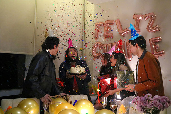 Group celebrating a surprise birthday party with confetti and gifts, highlighting guy’s female best friend and girlfriend dynamics. Group celebrating a surprise birthday party with confetti and gifts, highlighting guy’s female best friend and girlfriend dynamics.