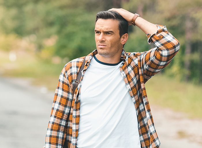 Man standing on side of the road looking confused and frustrated after a date goes wrong during a get out moment. Man standing on side of the road looking confused and frustrated after a date goes wrong during a get out moment.