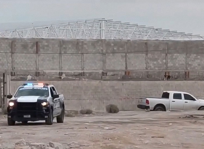 Police vehicles parked outside a large building during investigation of nearly 400 human bodies discovered stacked indoors. Police vehicles parked outside a large building during investigation of nearly 400 human bodies discovered stacked indoors.
