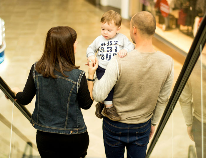 Young family with husband and wife holding their son, capturing a moment linked to husband feels sick realization about son's name. Young family with husband and wife holding their son, capturing a moment linked to husband feels sick realization about son's name.