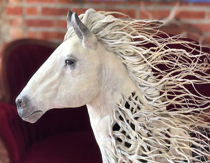 Horse sculpture made from scrap metal by artist, showcasing striking animal sculptures with detailed wire and gear design.